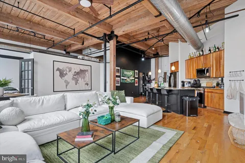 a living room with lots of furniture and kitchen view