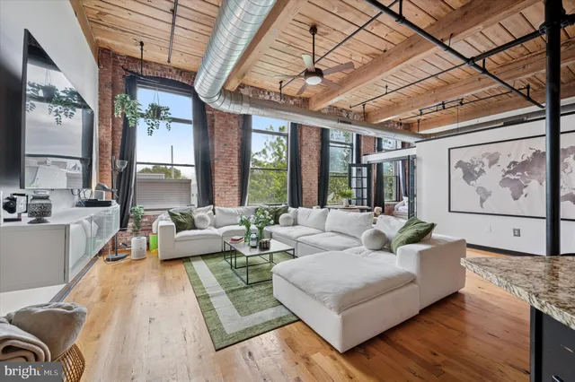 a living room with furniture and large windows