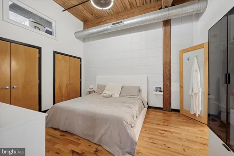 a bedroom with a bed and a mirror