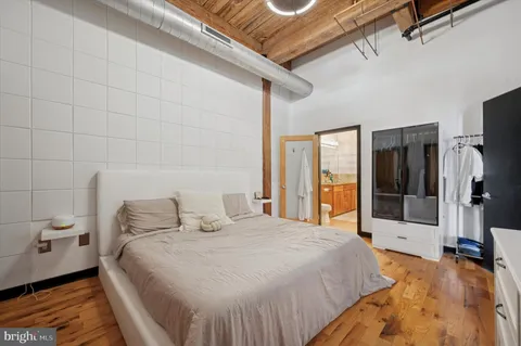 a bedroom with a bed and a large window