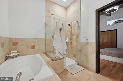 a bathroom with a bathtub and a shower