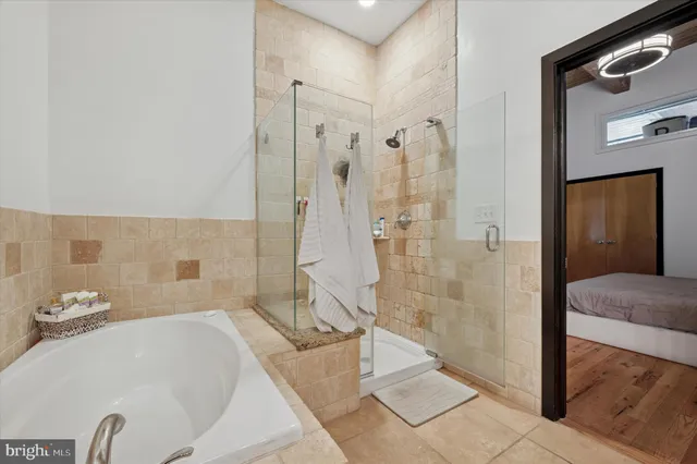 a bathroom with a bathtub and a shower