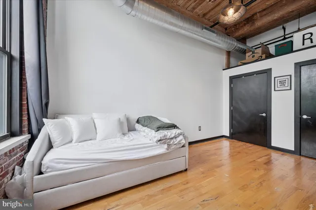 a spacious bedroom with a bed and a couch