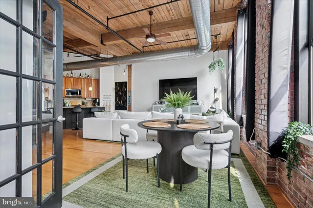 a view of a dining room with furniture window and wooden floor