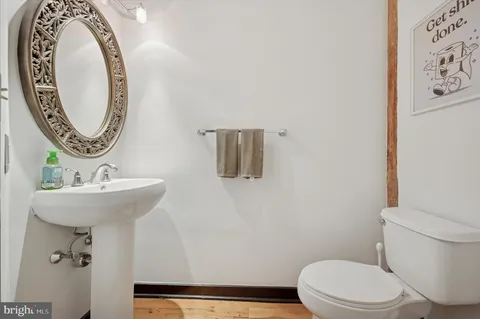a bathroom with a toilet a sink and a mirror