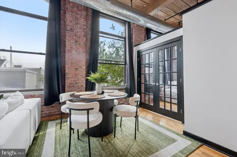 a dining room with furniture and wooden floor