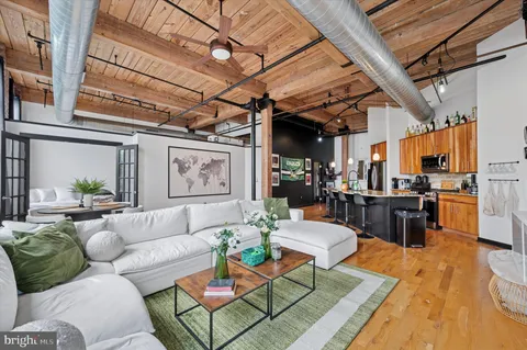 a living room with furniture and wooden floor