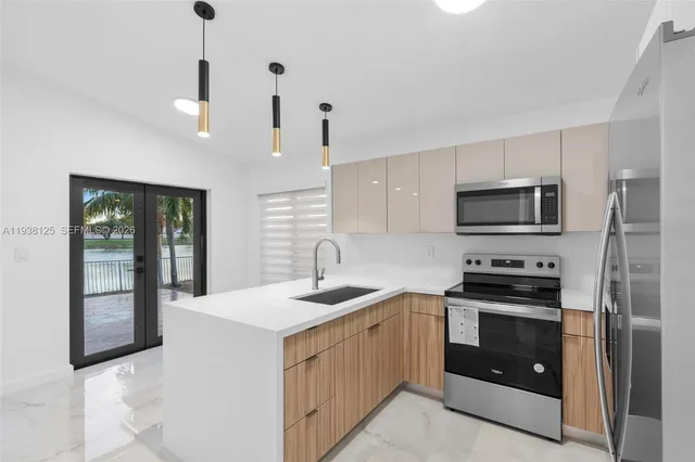 a kitchen with a sink stove and microwave