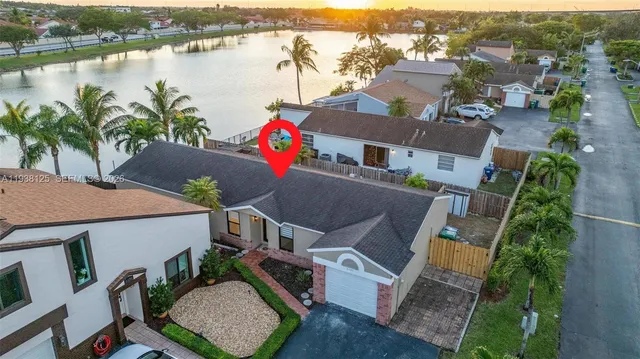 an aerial view of a house with outdoor space and lake view