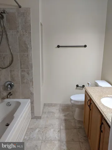 a bathroom with a sink a toilet and bathtub