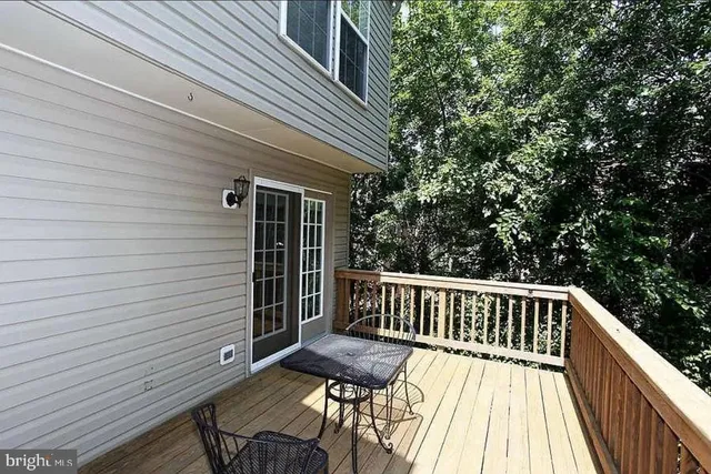 a view of balcony with wooden floor and outdoor seating