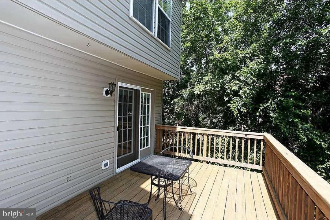 161 Ingle Place Alexandria, VA 22304 - Photo 20 of 21 a view of balcony with wooden floor and outdoor seating