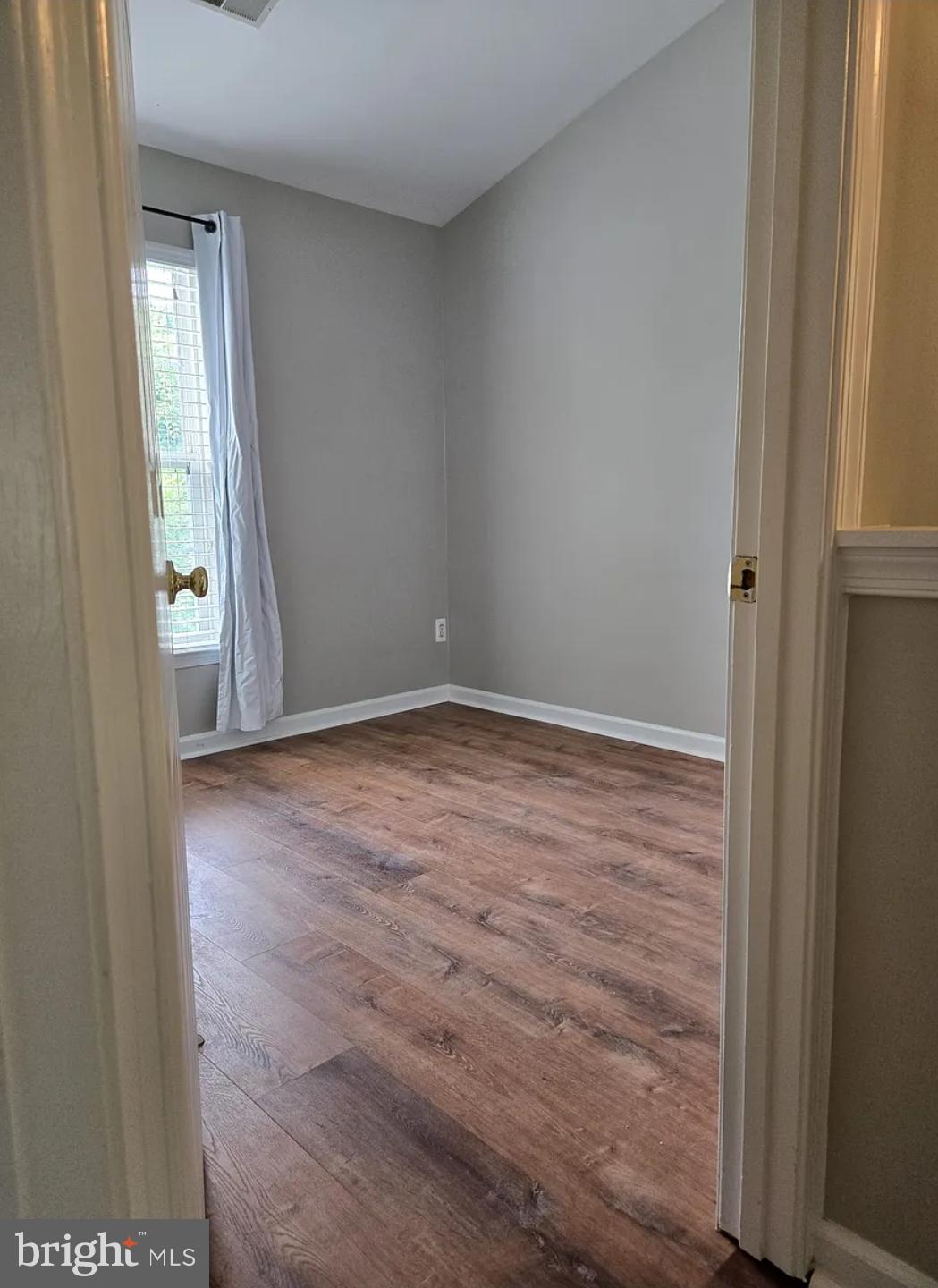 161 Ingle Place Alexandria, VA 22304 - Photo 8 of 21 an empty room with wooden floor and windows