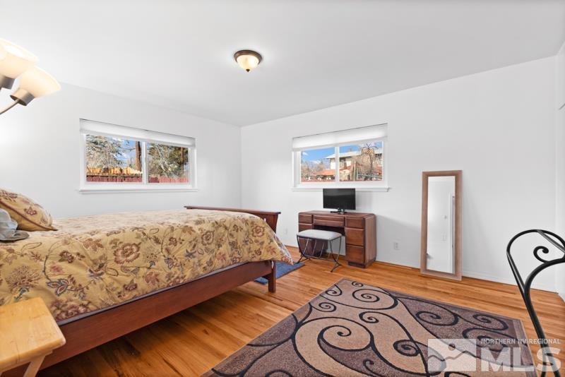 1051 Keystone Avenue Reno, NV 89503 - Photo 11 of 25 a bedroom with a bed and dresser with wooden floor