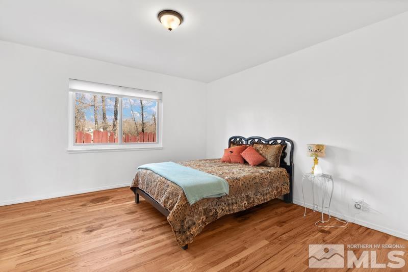 1051 Keystone Avenue Reno, NV 89503 - Photo 13 of 25 a bedroom with a bed and wooden floor