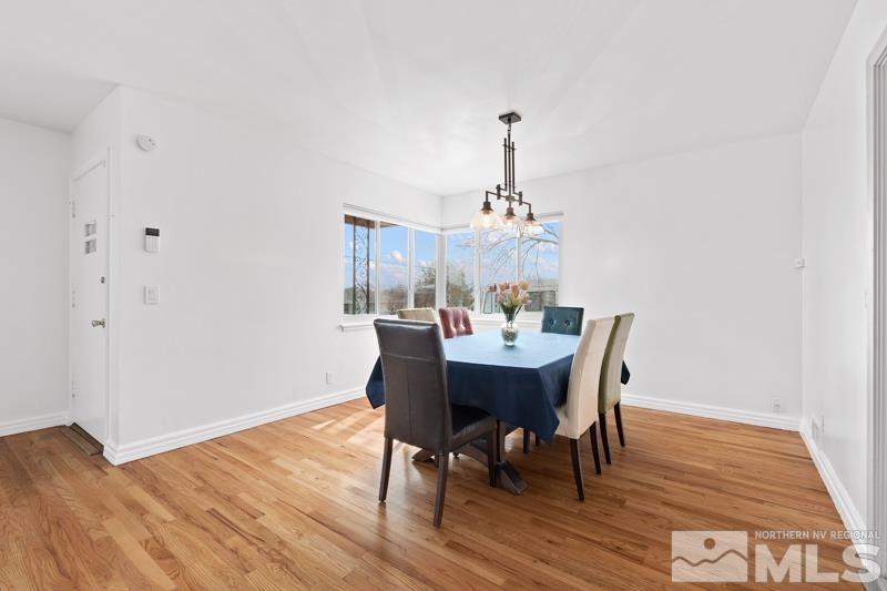 1051 Keystone Avenue Reno, NV 89503 - Photo 4 of 25 a view of a dining room with furniture wooden floor and chandelier