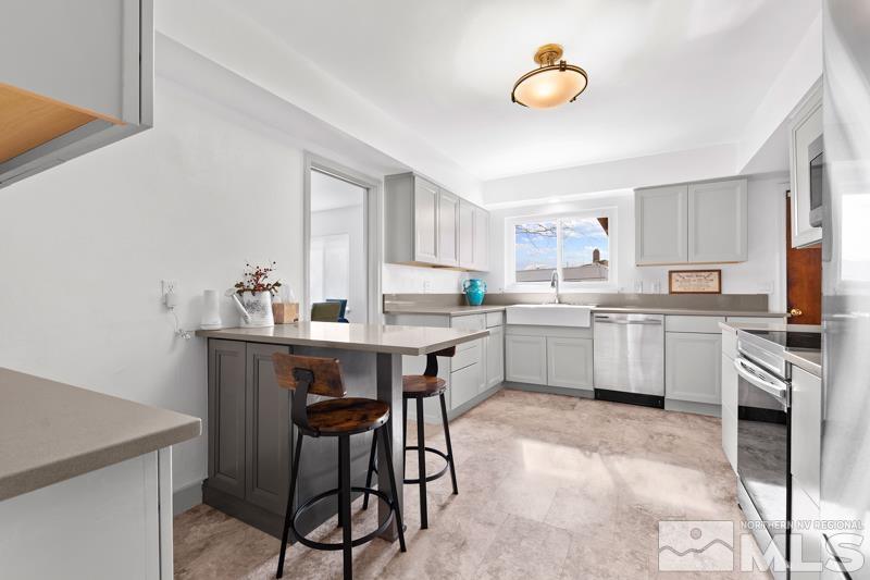 1051 Keystone Avenue Reno, NV 89503 - Photo 7 of 25 a kitchen with a table chairs sink and cabinets