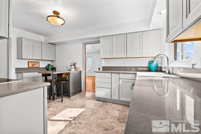 1051 Keystone Avenue Reno, NV 89503 - Photo 9 of 25 a kitchen with a sink cabinets and window
