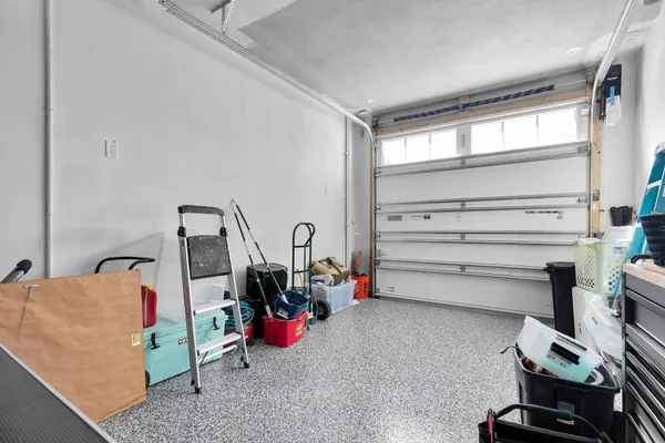 a view of a bedroom with baby crib and toys