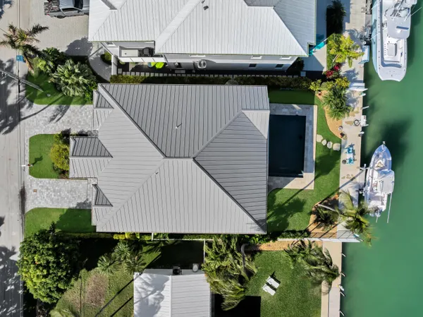 a kitchen with stainless steel appliances a stove a sink and white cabinets