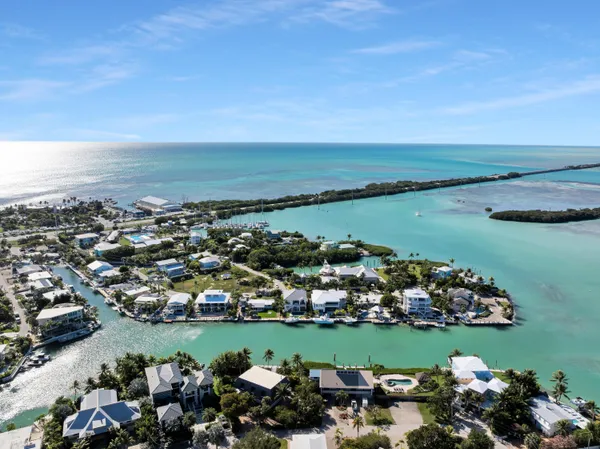 a kitchen that has a lot of cabinets in it and stainless steel appliances