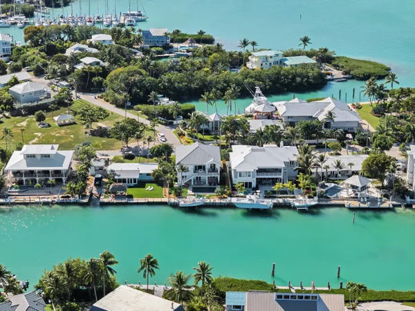 a kitchen with granite countertop a dining table chairs and white cabinets