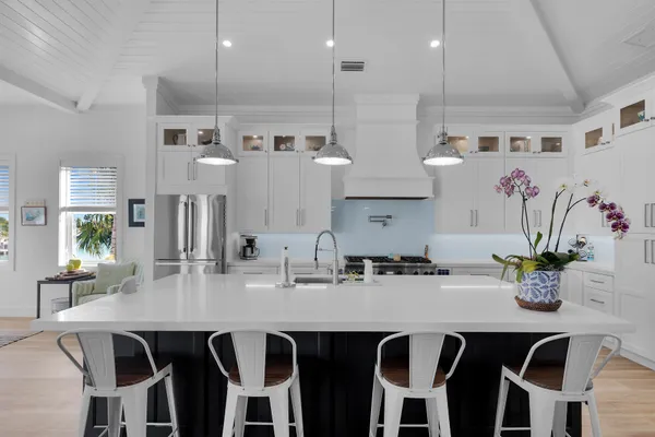 a front view of a building with swimming pool and furniture