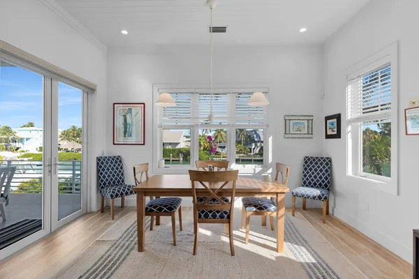 an aerial view of a residential houses with outdoor space and lake view in back