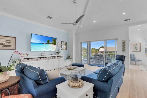 a living room with furniture and a kitchen