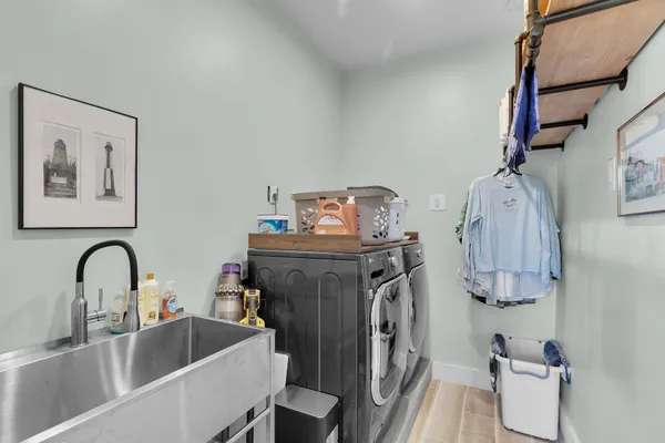 an aerial view of a residential houses with outdoor space and lake view in back