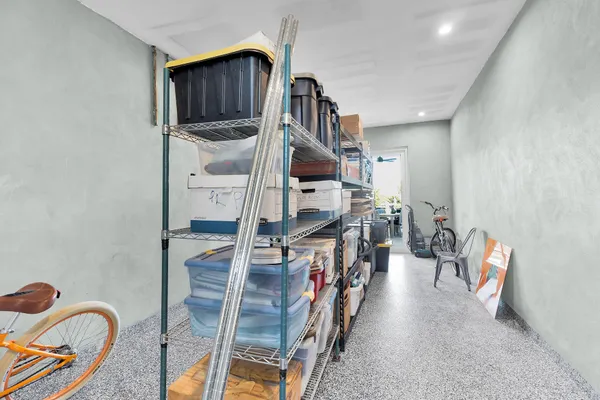 a front view of a house with a yard and potted plants