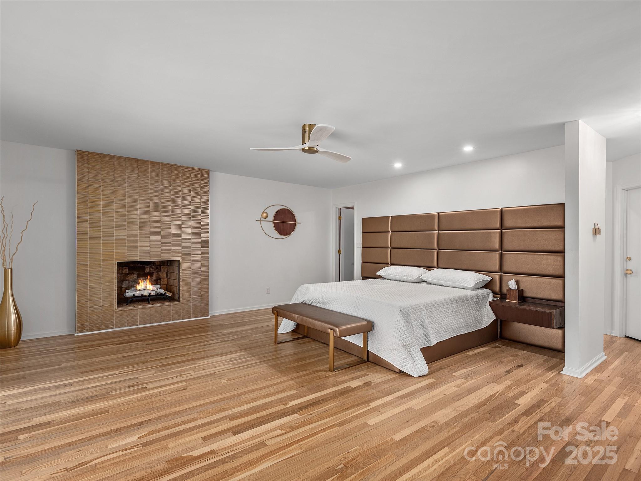 51 Rice Branch Road Asheville, NC 28804 - Photo 25 of 48 a spacious bedroom with a bed and a fireplace