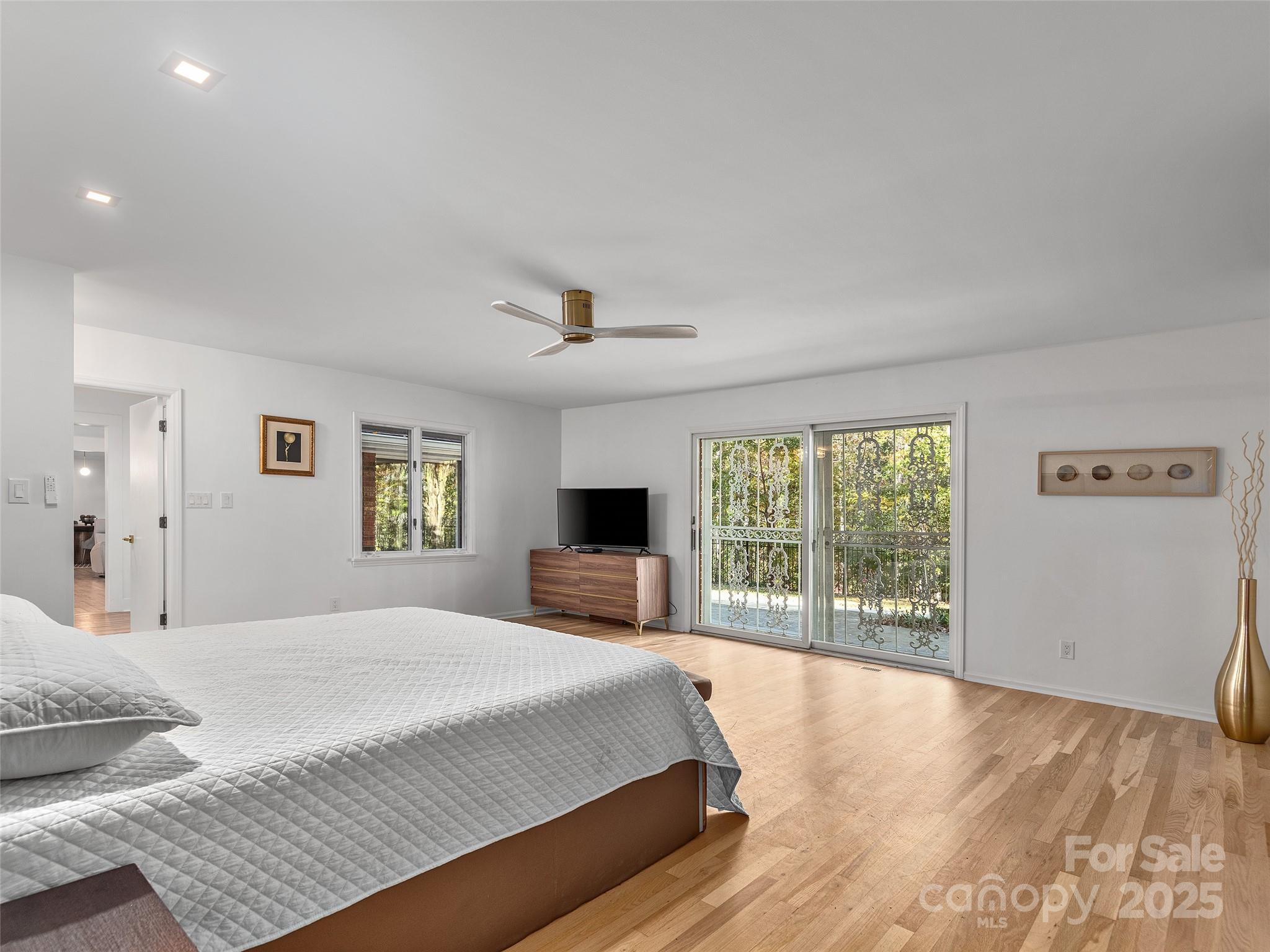 51 Rice Branch Road Asheville, NC 28804 - Photo 26 of 48 a spacious bedroom with a large bed and a large window