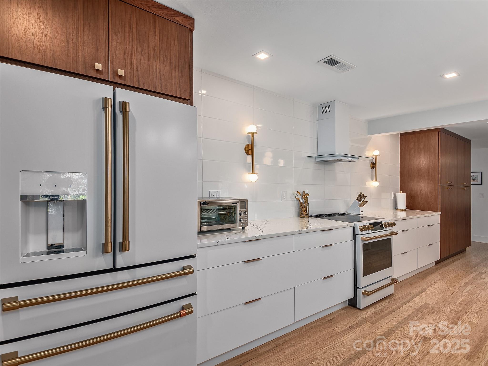 51 Rice Branch Road Asheville, NC 28804 - Photo 10 of 48 a kitchen with a stove a sink and a refrigerator