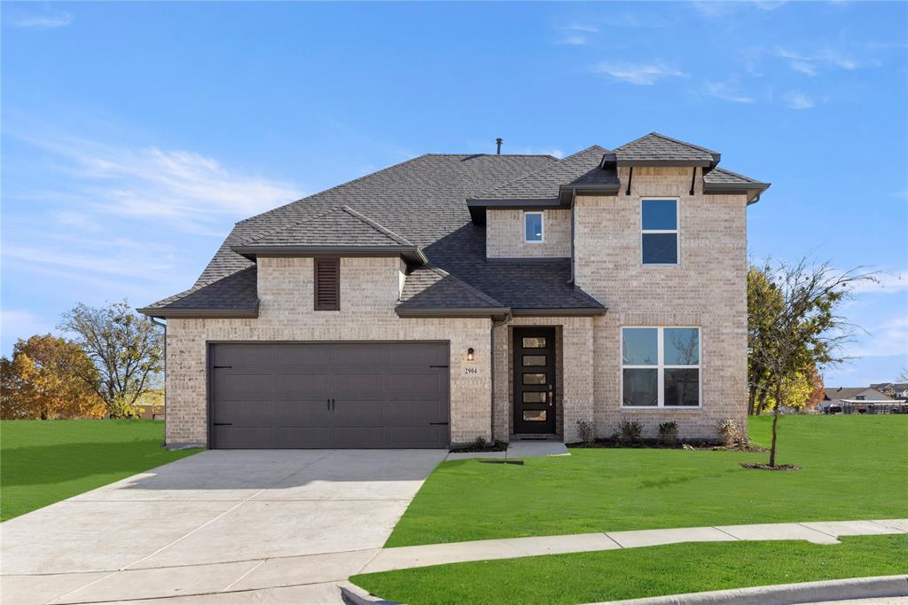 2504 Sturgis Street Forney, TX 75126 - Photo 1 of 1 a front view of a house with a garden