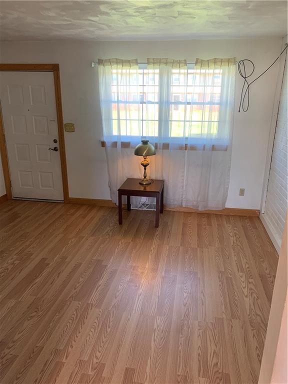 380 Northgate Drive, Unit D Apollo, PA 15613 - Photo 2 of 13 an empty room with wooden floor and windows