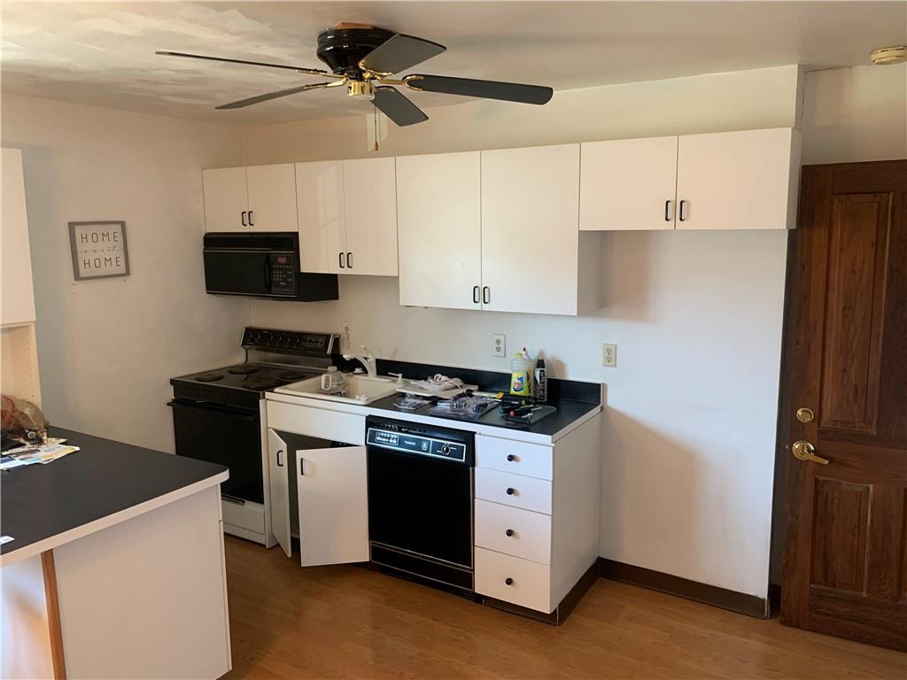 380 Northgate Drive, Unit D Apollo, PA 15613 - Photo 4 of 13 a kitchen with stainless steel appliances a stove a refrigerator a sink a microwave and cabinets