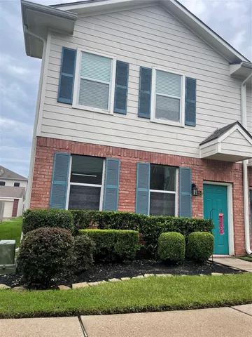 a view of a house with a small yard and plants