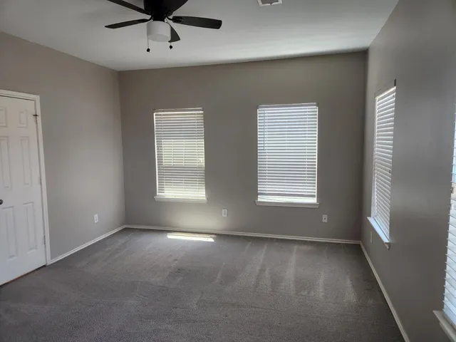 a view of room with window and ceiling fan