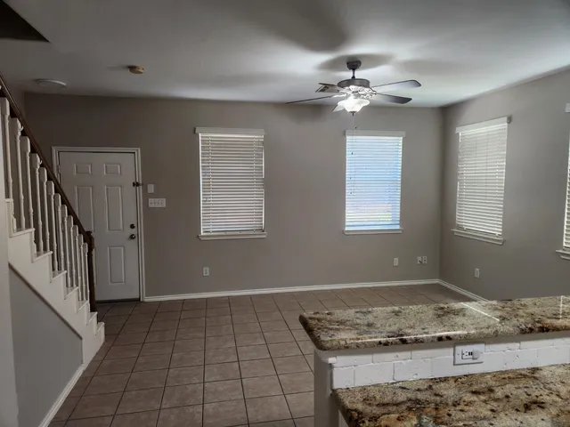 a view of a livingroom with a ceiling fan and window