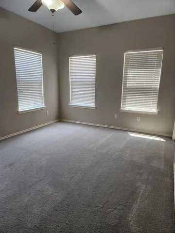 an empty room with a empty space and windows