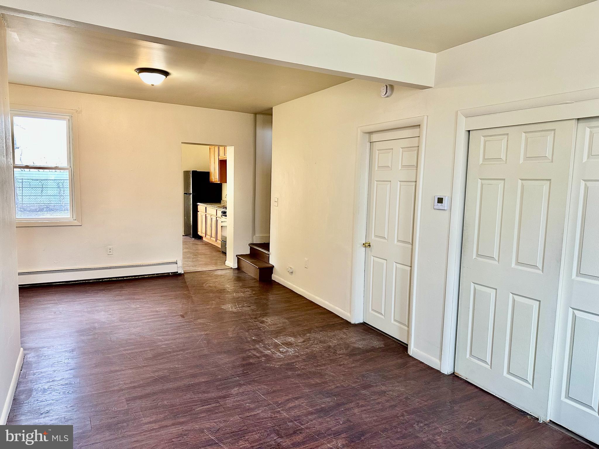 520 South Duke Street Lancaster, PA 17602 - Photo 3 of 13 an empty room with wooden floor and windows