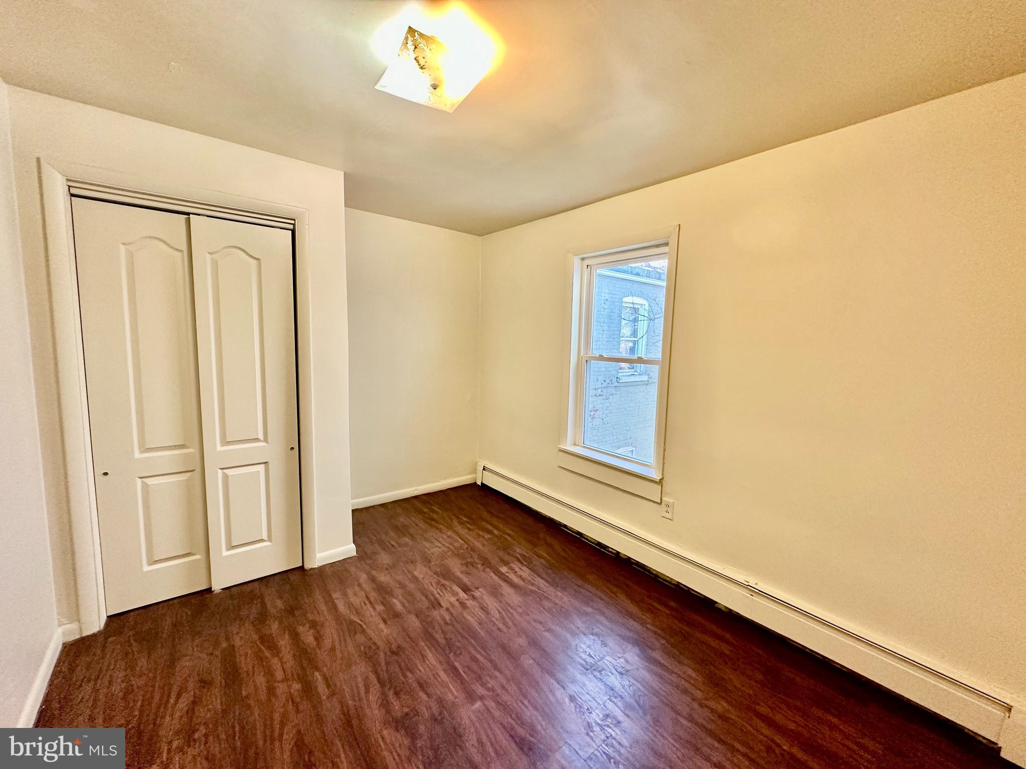 520 South Duke Street Lancaster, PA 17602 - Photo 8 of 13 a view of an empty room with wooden floor and a window