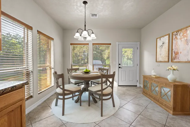 a large kitchen with granite countertop a stove a sink a refrigerator and a granite counter tops