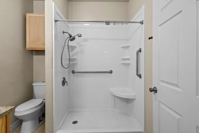 a bathroom with a sink mirror and toilet