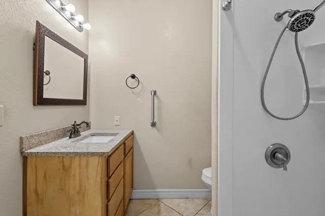 a view of a house with a yard and large trees