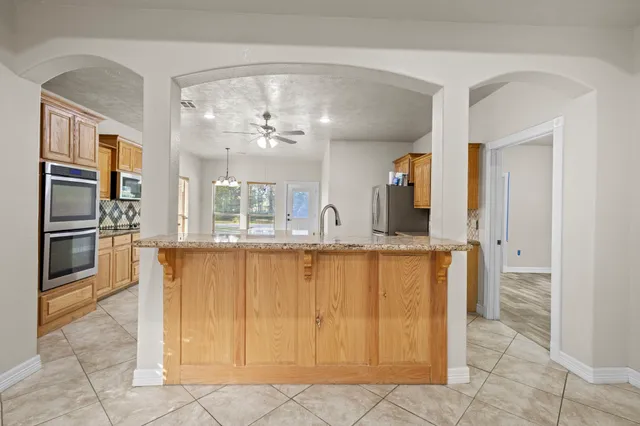 a kitchen with cabinets appliances and a counter space