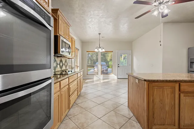 a kitchen with stainless steel appliances granite countertop a sink and cabinets