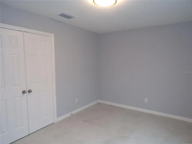 a white toilet sitting next to a white wall