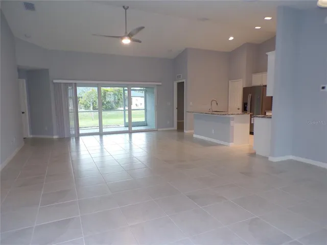 a kitchen with granite countertop white cabinets and a stove top oven
